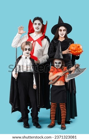 Happy family dressed for Halloween on blue background