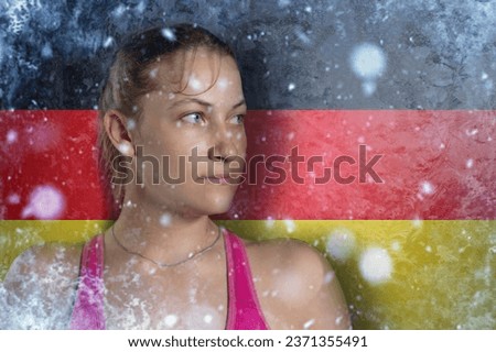 Young woman on frozen background with flag of Germany. Concept of crisis in Europe in winter. Energy crisis. Rising energy prices.