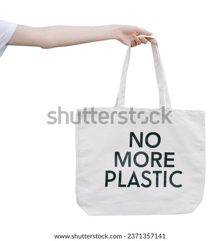 No more plastic eco tote bag in woman hands. No more plastic sign isolated on white background
