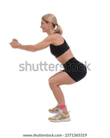 Woman exercising with elastic resistance band on white background