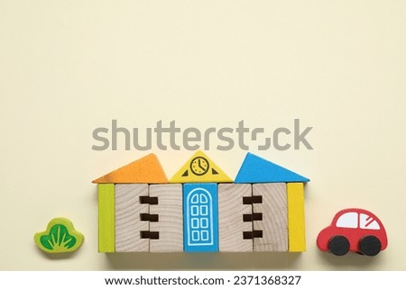 Set of wooden toys on beige background, flat lay with space for text. Children's development