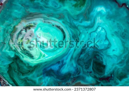 Closeup abstract color mixing of acrylic for use as background. Acrylic texture with marble pattern, green marbling background 
