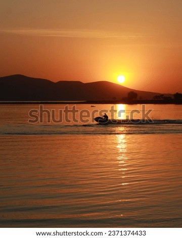 Photo of the Speed boat in Lake at the Sunset.