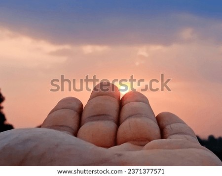 It's beautiful girl hand with morning red and blue sky.feel relax mood morning image.