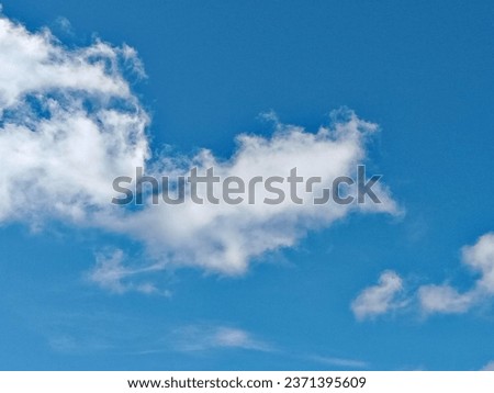 a photo of clouds in a clear summer sky 
