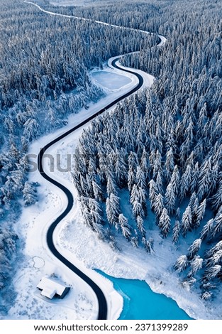 Overhead view of a road through a snow covered forest landscape in the far north of Canada - AI generated