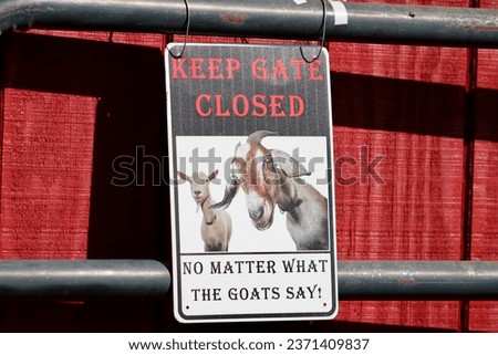 A sign that says "Keep Gate Closed No Matter What the Goat Says!".