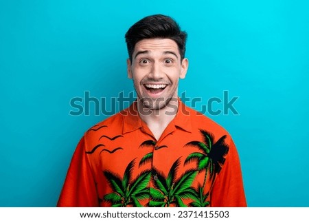 Portrait of shock astonished young guy big discount black friday buy tickets abroad travel for free advert isolated on blue color background