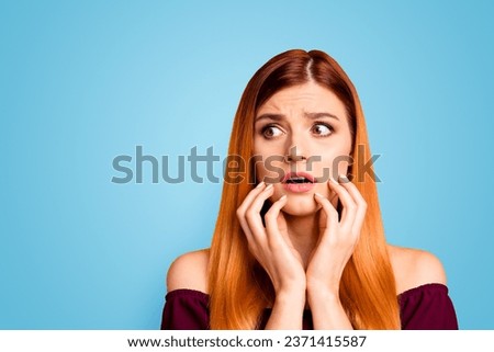 Oh no Human emotions concept. Close up portrait of confused beautiful woman with open mouth big eyes isolated on yellow background. Young scared girl touch one's face with hands and look aside Royalty-Free Stock Photo #2371415587