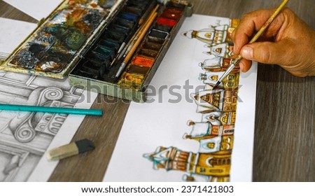The animator draws the characters of cartoons, comics or puppet shows. Festive Christmas motifs. Preparation for making scenery for a puppet show. Christmas holiday.