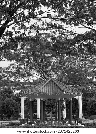 This black and white photo of a gazebo in a park is a stunning depiction of tranquility and peace. The gazebo's intricate details are perfectly captured in the crisp black and white tones.