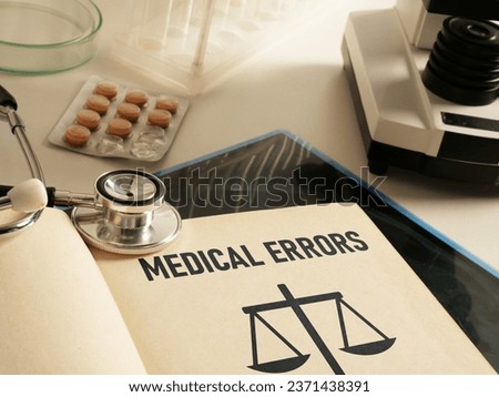 Medical errors are shown using a text in the book and photo of stethoscope Royalty-Free Stock Photo #2371438391