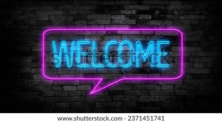 Welcome neon sign on brick wall background.