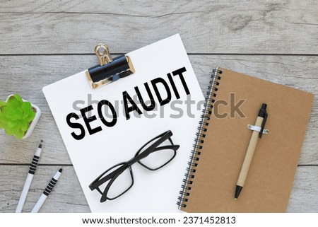 SEO AUDIT. Business concept. text on white A4 paper on a work table