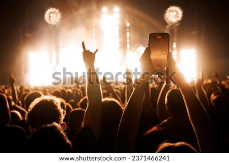 People Taking Photos At A Music Concert With Smartphones