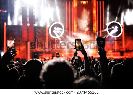 Streaming a music concert to social media via smartphone.