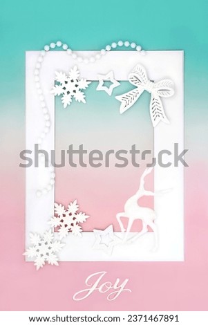 Christmas reindeer white tree decorations on white frame on pink and green background. Festive North pole fantasy theme for the holiday season.