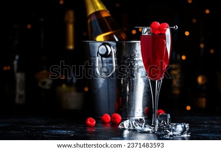 Moulin rouge cocktail drink with calvados, sparkling wine, lychee and raspberry peach puree and ice, dark bar counter background Royalty-Free Stock Photo #2371483593