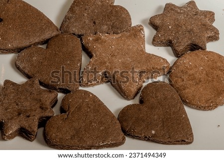 Closeup of chocolate heart shape cookies served on a white plate