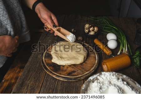 Girl preparing dough in the kitchen
