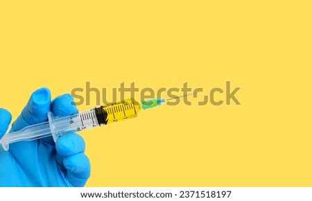 Lyme disease concept. a vaccine on a doctor's hand in yellow background