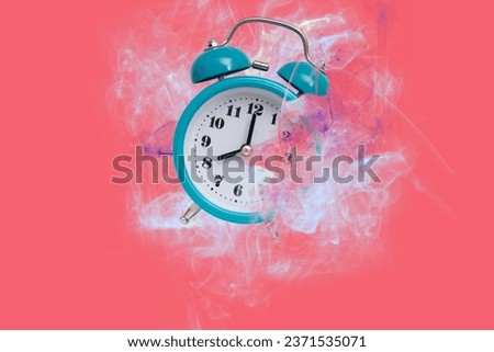 The time is running out. Dissolving in smoke alarm clock disappears on pink background.
