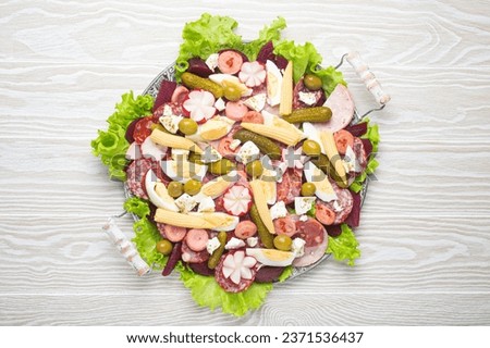 Fiambre, salad of Guatemala, Mexico and Latin America, on large plate top view white wooden background top view. Festive dish for All Saints Day (Day Of The Dead) celebration Royalty-Free Stock Photo #2371536437