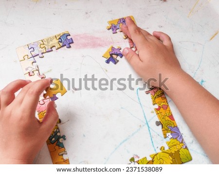 A boy collects a picture puzzle educational games for children