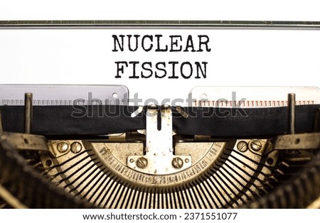 Nuclear fission symbol. Concept words Nuclear fission typed on beautiful old retro typewriter. Beautiful white paper background. Business science nuclear fission concept. Copy space. Royalty-Free Stock Photo #2371551077