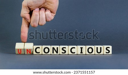 Conscious or unconscious symbol. Concept words Conscious Unconscious on wooden blocks. Beautiful grey table grey background. Psychologist hand. Psychology conscious or unconscious concept. Copy space. Royalty-Free Stock Photo #2371551157
