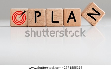Plans symbol. The concept word 'plans' on wooden cubes on a beautiful white table. White background. Business and plan or plans concept.