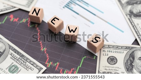 Business concept. Against the background of a calculator, documents and money, a man holds a sign with the inscription - LATEST INVESTING NEWS Royalty-Free Stock Photo #2371555543