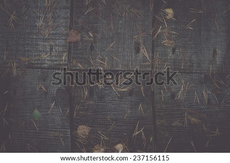 old wooden planks covered with autumn leaves - retro, vintage style look