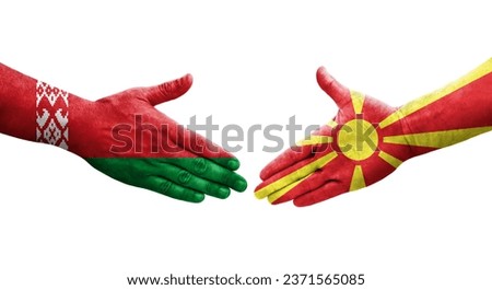 Handshake between North Macedonia and Belarus flags painted on hands, isolated transparent image.