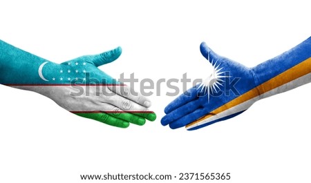 Handshake between Uzbekistan and Marshall Islands flags painted on hands, isolated transparent image.
