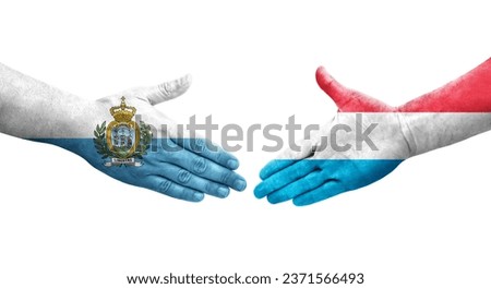 Handshake between Luxembourg and San Marino flags painted on hands, isolated transparent image.
