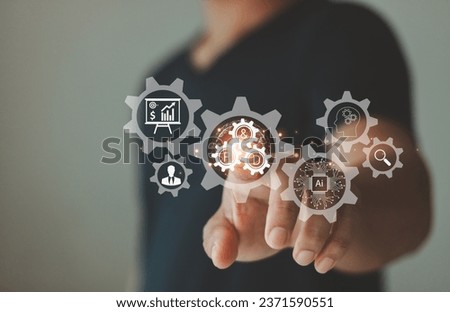 New product development or software development concept. Using AI in the design process. Businessman pointing to R and D cog research and development and gear icons as a continuous process automation. Royalty-Free Stock Photo #2371590551