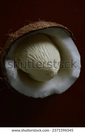 Coconut apple or coconut crumb on the open fruit on a wooden board. Exotic fruit known as coconut bread. Maçã do côco 