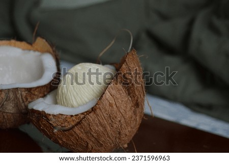 Coconut apple or coconut crumb on the open fruit on a wooden board. Exotic fruit known as coconut bread. Maçã do côco 