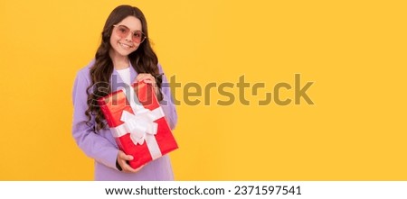shopping time. cheerful kid hold present. child prepare for holiday. happy valentines day. Kid girl with gift, horizontal poster. Banner header with copy space.