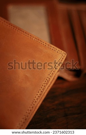 Wallet, cards, credit. Stylish leather wallet in box on wooden background. Leather wallet on wood texture. Leather craftsman. Leather Craft.