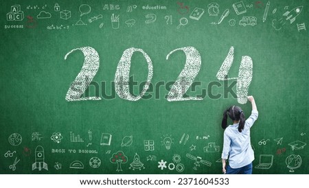 2024 Happy new year school class academic calendar with student kid's hand drawing greeting on teacher's green chalkboard for educational celebration, back to school, STEM education classroom schedule Royalty-Free Stock Photo #2371604533