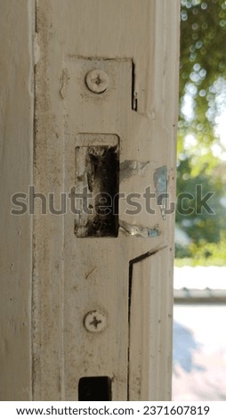 photo of door hole filled with worn cobwebs
