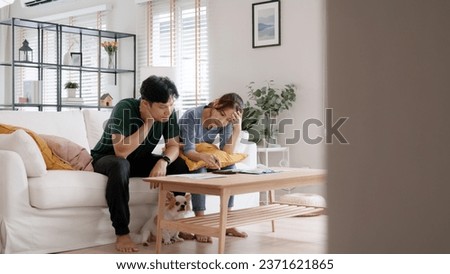 Rising high cost of living in low poor income asia people family. Past due bill debt home loan money issue young adult asian couple man woman worry shock sad tired stress in raise tax rate crisis Royalty-Free Stock Photo #2371621865
