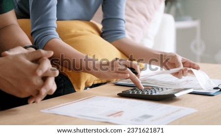 Rising high cost of living in low poor income asia people family. Past due bill debt home loan money issue young adult asian couple man woman worry shock sad tired stress in raise tax rate crisis Royalty-Free Stock Photo #2371621871