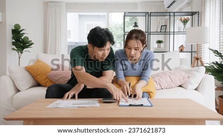Rising high cost of living in low poor income asia people family. Past due bill debt home loan money issue young adult asian couple man woman worry shock sad tired stress in raise tax rate crisis Royalty-Free Stock Photo #2371621873