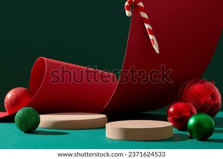 A candy cane hanging on red paper, two podiums arranged with red and green baubles. Christmas has never failed to attract people with various ways to celebrate in different nations