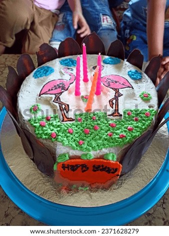 A cute birthday cake with a picture of a flamingo bird