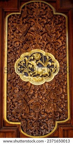 Wood carving of Thai asterism years sign in buddhist temple.