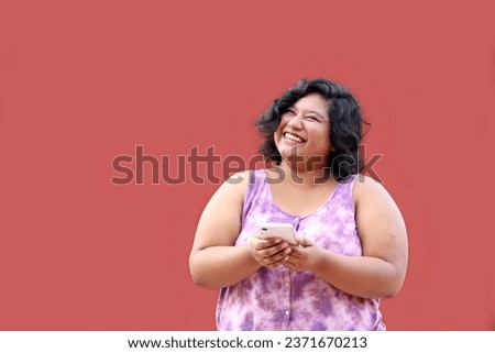 20 year old fat brunette Latina woman uses her cell phone to send messages, shop and date romantically Royalty-Free Stock Photo #2371670213
